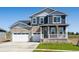 Charming two-story home with a stone facade and a well-manicured front yard at 1102 Ridgefield Dr, Berthoud, CO 80513