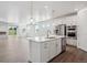 Modern kitchen with stainless steel appliances, a central island, and an open floor plan at 1102 Ridgefield Dr, Berthoud, CO 80513