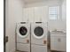 Laundry room featuring a sink and two front loading washers and dryers at 1102 Ridgefield Dr, Berthoud, CO 80513