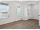 Bright living room with wood floors, white walls, and large windows with white blinds at 1102 Ridgefield Dr, Berthoud, CO 80513