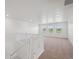 Bright loft area features neutral carpeting, lots of natural light and white staircase railing at 1102 Ridgefield Dr, Berthoud, CO 80513