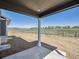 Covered patio shows a spacious outdoor area with views of the surrounding landscape and fence at 1102 Ridgefield Dr, Berthoud, CO 80513