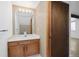 A well-lit bathroom featuring a single vanity, framed mirror and traditional design elements at 1770 S Quintero Way, Aurora, CO 80017