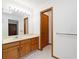 Bathroom featuring a single vanity with a well-lit mirror and a neutral color palette for a serene feel at 1770 S Quintero Way, Aurora, CO 80017