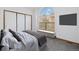 Inviting bedroom with a large window, built-in bench, ample closet space, and modern grey color palette at 1770 S Quintero Way, Aurora, CO 80017