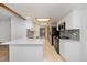 Bright kitchen features white cabinets, stainless steel appliances, and tiled floor at 1770 S Quintero Way, Aurora, CO 80017