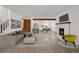 This open-concept living room features a modern fireplace and is adjacent to the dining area and kitchen at 1770 S Quintero Way, Aurora, CO 80017