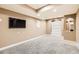 Finished basement has neutral carpet, recessed lights and TV, a perfect area to create a media or entertainment room at 736 Trenton St, Denver, CO 80230