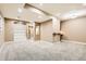 Finished basement offers neutral paint, carpeted floors, recessed lights and built in shelves for flexible living space at 736 Trenton St, Denver, CO 80230