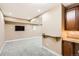 The basement features neutral carpet and kitchenette, offering a practical space for relaxation and entertainment at 736 Trenton St, Denver, CO 80230