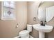 Neutral powder room featuring a decorative window and pedestal sink at 736 Trenton St, Denver, CO 80230