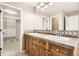 Bathroom with double sinks, granite countertop and a large mirror at 736 Trenton St, Denver, CO 80230