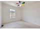 Bright, neutral bedroom featuring a ceiling fan and light-filled window at 736 Trenton St, Denver, CO 80230
