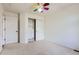 Neutral bedroom with a colorful ceiling fan and built in closet storage and shelving at 736 Trenton St, Denver, CO 80230