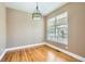 Dining room with hardwood floors, natural light, and modern decorative light fixture at 736 Trenton St, Denver, CO 80230