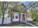 Charming two-story home boasts a welcoming front porch and beautifully maintained landscaping at 736 Trenton St, Denver, CO 80230
