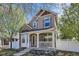 Charming two-story home boasts a welcoming front porch and beautifully maintained landscaping at 736 Trenton St, Denver, CO 80230