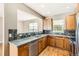 Well-lit kitchen featuring wooden cabinets, neutral countertops, and stainless steel appliances at 736 Trenton St, Denver, CO 80230