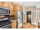 Kitchen with stainless steel appliances, granite countertops, and wooden cabinets at 736 Trenton St, Denver, CO 80230