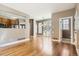Open floor plan with hardwood floors leading to sliding doors and a modern kitchen with open concept to the dining area at 736 Trenton St, Denver, CO 80230