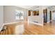 Bright living room featuring hardwood floors, a large window, and an open view into the kitchen at 736 Trenton St, Denver, CO 80230