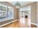 Open-concept living room with hardwood floors, large windows, and a fireplace at 736 Trenton St, Denver, CO 80230