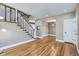 Bright living room featuring hardwood floors and a staircase with white wood detail at 736 Trenton St, Denver, CO 80230