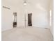 Spacious main bedroom with light-filled window, carpet, and ensuite bathroom at 736 Trenton St, Denver, CO 80230