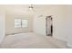 Spacious main bedroom with light-filled window, carpet, and ensuite bathroom at 736 Trenton St, Denver, CO 80230