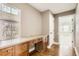 Bright office area with custom built-in desk and cabinets, window and hardwood floors, ideal for a home office at 736 Trenton St, Denver, CO 80230