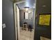 Bathroom with mirror, linoleum floors, a light and a humorous sign at 10211 Ura Ln # 5-206, Thornton, CO 80260
