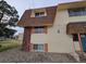 Multi-Gathering townhouse exterior with brown shingled roof, tan siding, brick, and rocks at 10211 Ura Ln # 5-206, Thornton, CO 80260