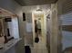 Hallway with white tile flooring and neutral colored walls at 10211 Ura Ln # 5-206, Thornton, CO 80260