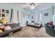 Comfortable carpeted bedroom with ample natural light, including a sofa and a personal desk at 6302 E 135Th Ave, Thornton, CO 80602
