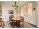 Elegant dining room with hardwood floors, a chandelier, and a vintage radio at 6302 E 135Th Ave, Thornton, CO 80602
