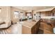 Bright kitchen features granite countertops, wood floors, and brown cabinets at 6302 E 135Th Ave, Thornton, CO 80602