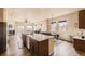 Open kitchen and living room layout with wood floors and fireplace at 6302 E 135Th Ave, Thornton, CO 80602