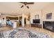 Open concept living room and kitchen area with hardwood floors and a fireplace at 6302 E 135Th Ave, Thornton, CO 80602