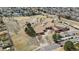 An aerial view features the local school, grounds, playground, and parking at 3656 E 134Th Dr, Thornton, CO 80241