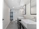 Bathroom boasts double vanity, framed mirrors, shower with glass door, and modern fixtures at 3656 E 134Th Dr, Thornton, CO 80241