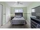 A bedroom with light green walls, neutral carpet, and a twin-sized bed at 3656 E 134Th Dr, Thornton, CO 80241