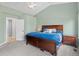 A cozy bedroom with a queen-sized bed, neutral carpet, and light green walls at 3656 E 134Th Dr, Thornton, CO 80241