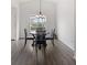 Cozy dining area with a round table, four chairs, and modern light fixture at 3656 E 134Th Dr, Thornton, CO 80241