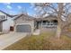 Charming home featuring manicured lawn, attached garage, and cozy front porch at 3656 E 134Th Dr, Thornton, CO 80241