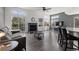 Bright living room featuring a fireplace, large windows, and an open floor plan at 3656 E 134Th Dr, Thornton, CO 80241