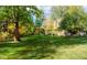 Large backyard lawn with mature trees and foliage with a swing hanging from one of the branches at 3737 26Th St, Boulder, CO 80304