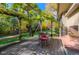 Outdoor patio area with wood deck, bench, wrought iron table and lush green lawn with mature trees at 3737 26Th St, Boulder, CO 80304