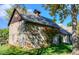 Exterior view of stone building with wood doors and mature foliage in the yard at 3737 26Th St, Boulder, CO 80304