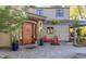A welcoming entrance boasts a beautiful wood door, manicured landscaping, and a cozy seating area at 3737 26Th St, Boulder, CO 80304