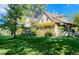 Attractive home featuring a lush green lawn, mature trees, and stone accents at 3737 26Th St, Boulder, CO 80304
